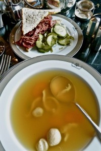 Half salt beef sandwich served with chicken soup and dumplings