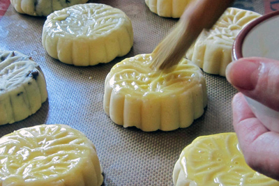 Brushing glaze onto moon cakes. Credit: Carolyn Phillips