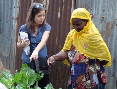 Danielle Nierenberg visits with one of the female farmers growing food in vertical gardens in Nairobi's Kibera slum. Credit: Bernard Pollack