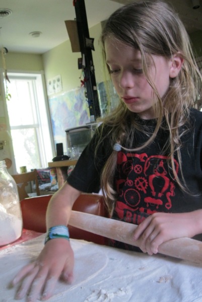 Felix, 10, demonstrates rolling out dough. Credit: Amy Halloran