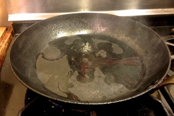 Carbon steel sauté pan on high heat, smoke rising from the blended oil. Credit: David Latt