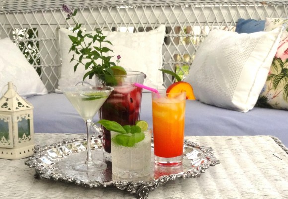 Summer cocktails on the porch: a margarita, blackberry Moscow mule, tequila sunrise and basil mojito. Credit: Rose Winer