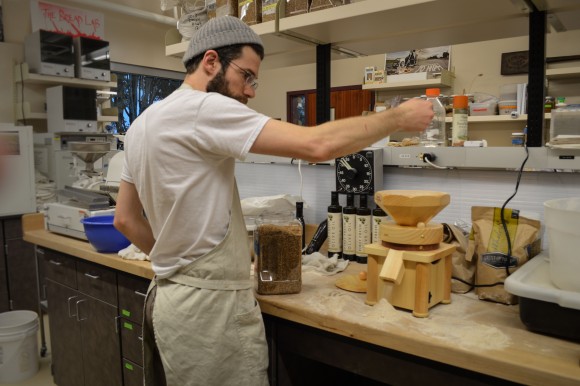 Jonathan Bethony mills wheat for flour at The Bread Lab. Photo credit: Kim Binczewski