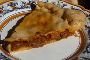 Stuffed pizza with mixed offal in spicy tomato sauce or “pizza with guts.” Credit: Clifford A. Wright