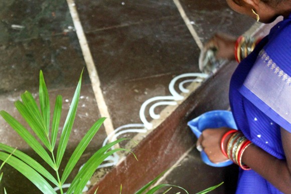 For the Makara Sankranti festival, some Indian families decorate their homes to celebrate the harvest, like this woman drawing Alpona, a traditional Bengali rice paste decoration. Credit: Rinku Bhattacharya