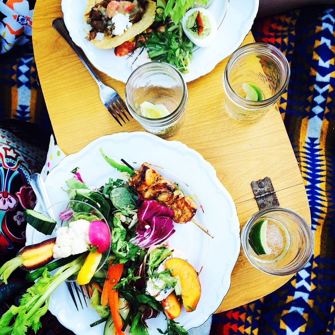 Forget the plastic knives and forks. Glam up your picnic with jam jars and everyday kitchenware. Credit: Copyright Andrea Slonecker