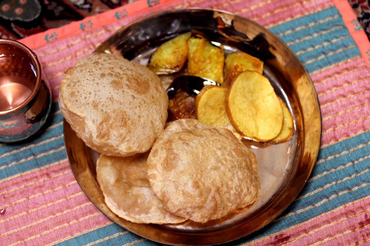 Begun Bhaja, or Bengali Fried Eggplants, with luchi, a puffed bread. Credit: Copyright 2015 Rinku Bhattacharya