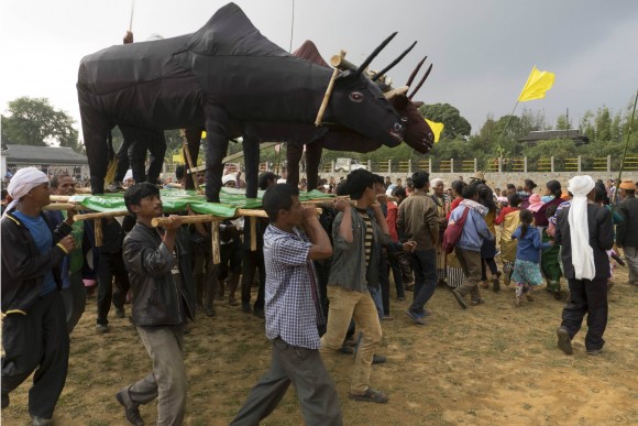 Villagers dance at the Beh Dienkhlam festival in Mosakhia as men carry a life-sized oxen effigy. Credit: Copyright 2015 Carla Capalbo