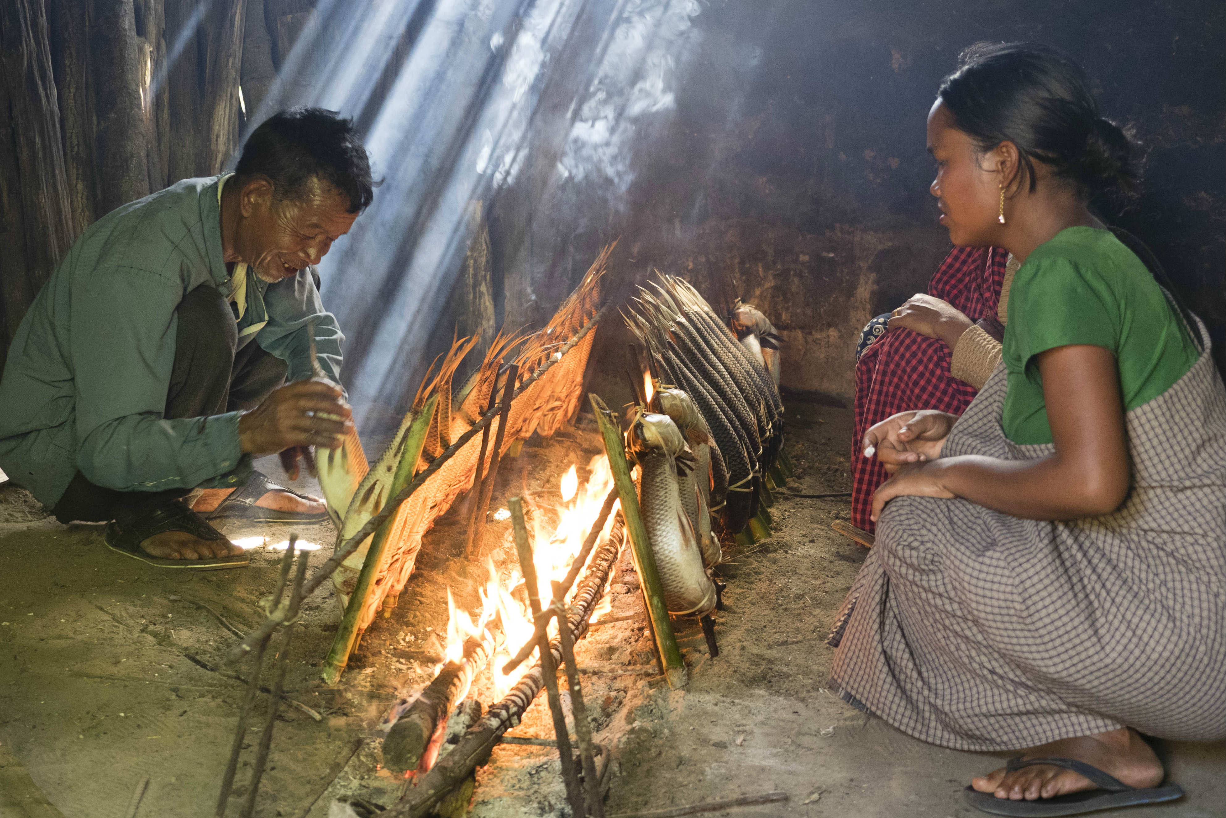 Fish are smoked for several hours beside the fire in the rural village of Umladkhur. Credit: Copyright 2015 Carla Capalbo