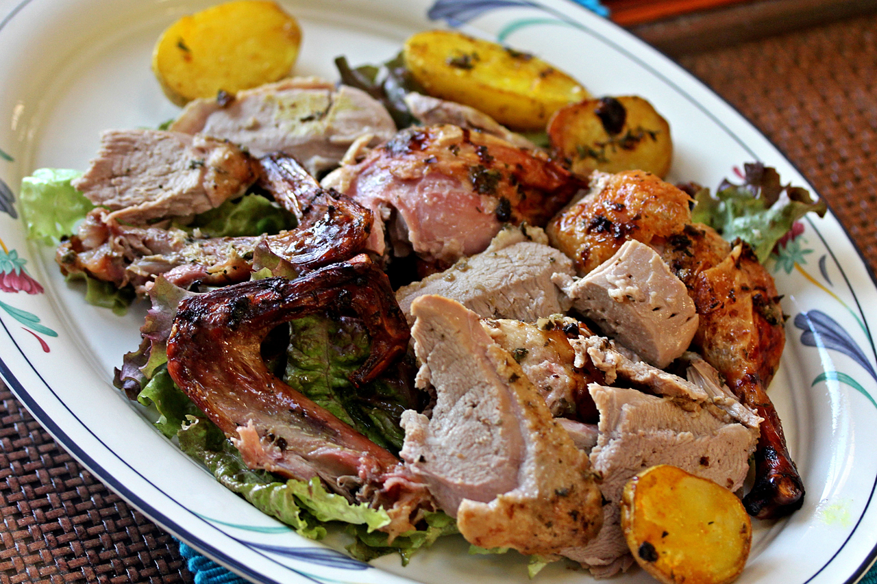 A platter of carved Spicy Roast Garlic and Curry Leaf Duck, with a side of roasted potatoes. Credit: Copyright 2015 Rinku Bhattacharya