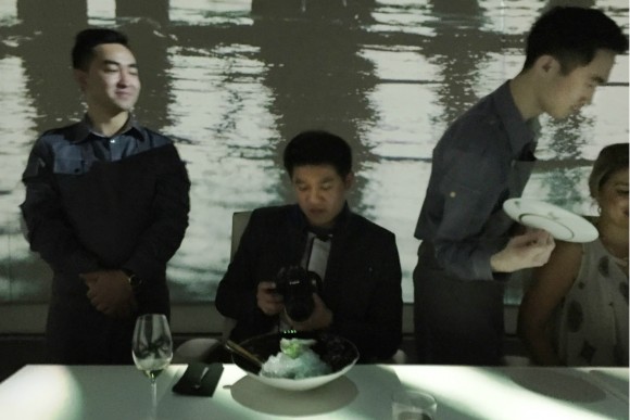 Waiters, whose every move is choreographed, serve diners at Ultraviolet. Credit: Copyright 2015 Nicholas Gilman