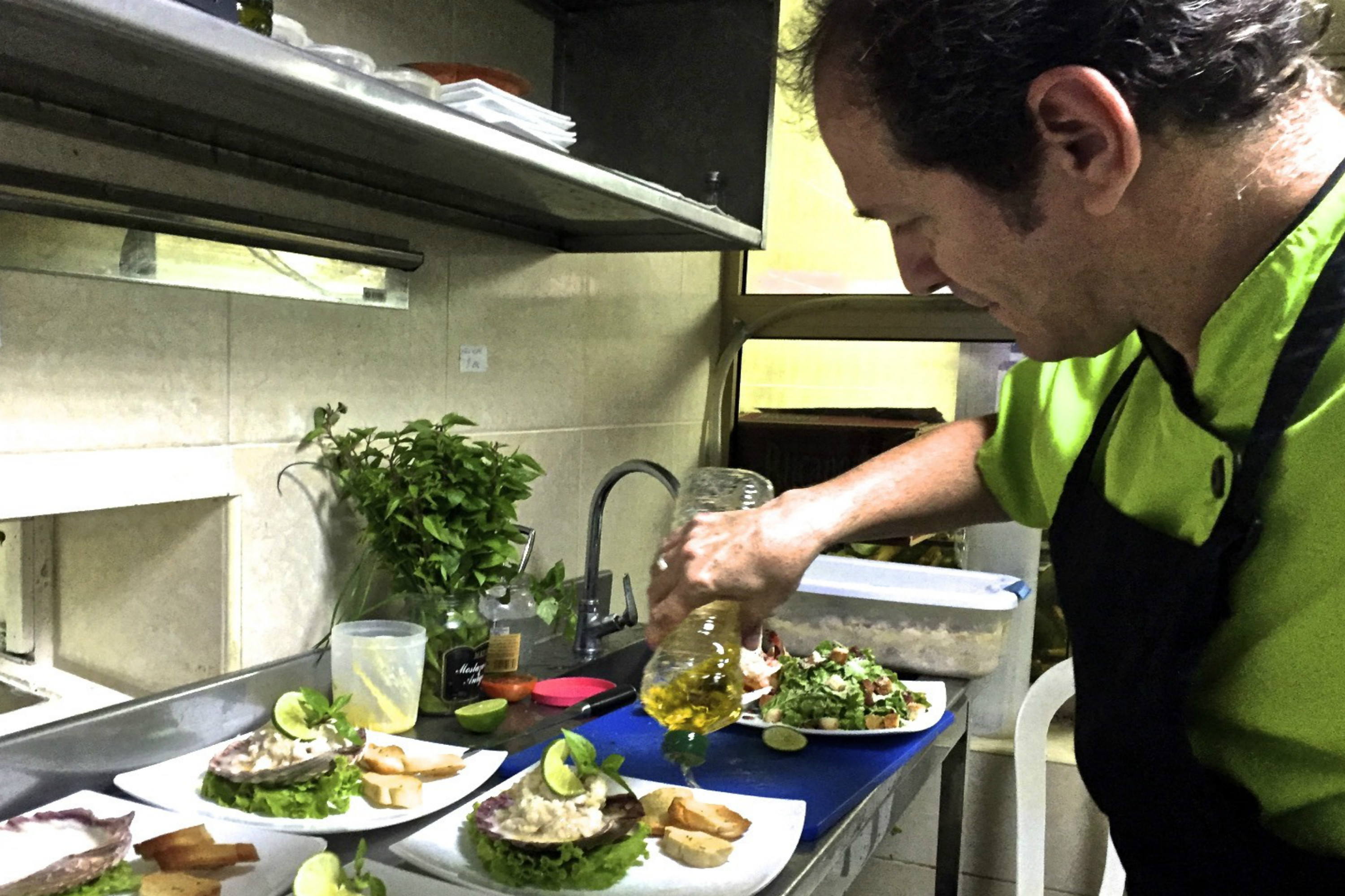 Chef Boris Panta in the kitchen at Paladar Vistamar platting red snapper ceviche. Credit: Copyright 2016 David Latt