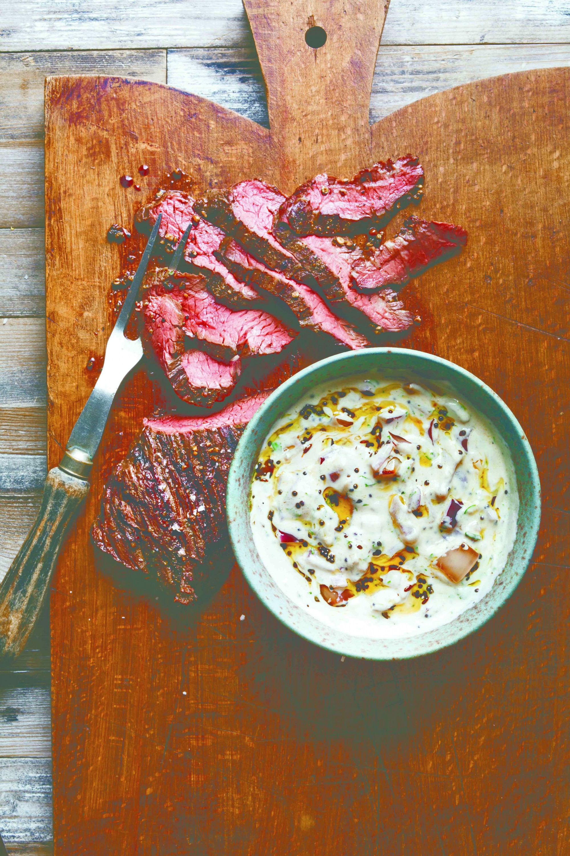 Grilled hanger steak with grilled red-onion raita. Credit: Reprinted with permission from "Yogurt," by Janet Fletcher, copyright 2015, published by Ten Speed Press, an imprint of Penguin Random House LLC
