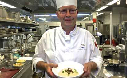 Chef Olivier Rais in his kitchen at Rive Gauche in Zurich's Hotel Baur au Lac with a serving of his vegan risotto. Credit: Copyright 2017 David A. Latt