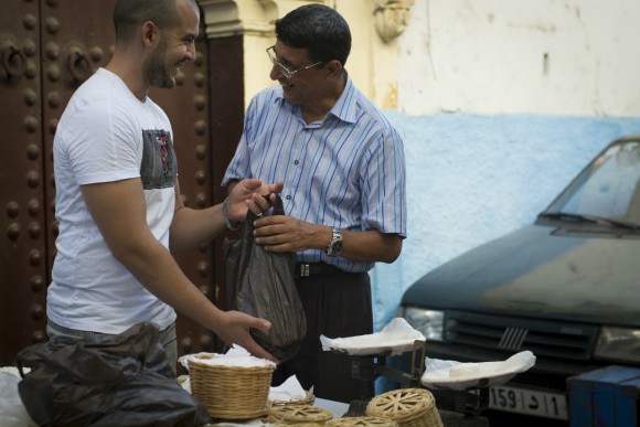 Abdelatif Reda, 30, engages with one of his regular customers. He has been selling his product since he was 13. Credit: Copyright 2014 Eloise Schieferdecker