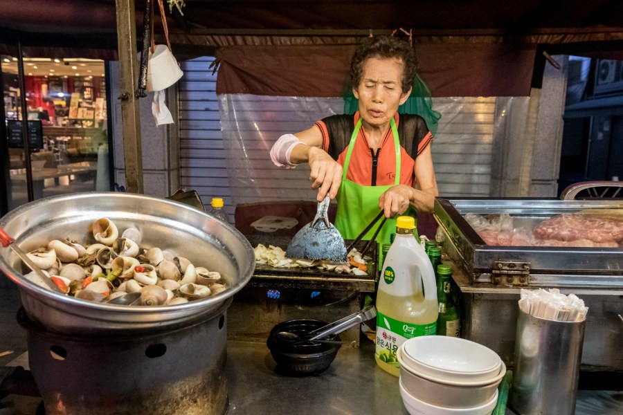 Kim Il-sun prepares dalkgalbe -- spicy chicken with vegetables, stir-fried in soju -- at Auntie's Soju Tent. Credit: Copyright 2016 Jo Turner